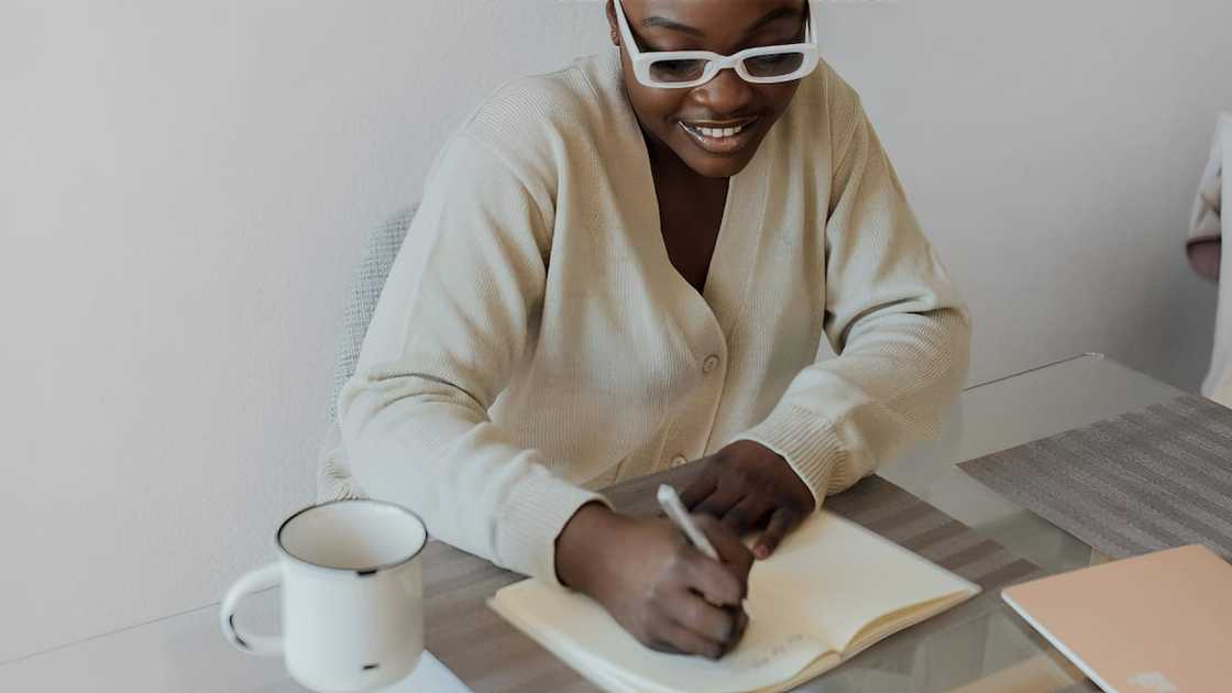 A woman writing in her notebook