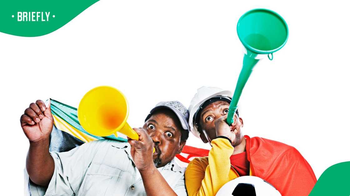 South African soccer fans using vuvuzelas. South African soccer fans using vuvuzelas.