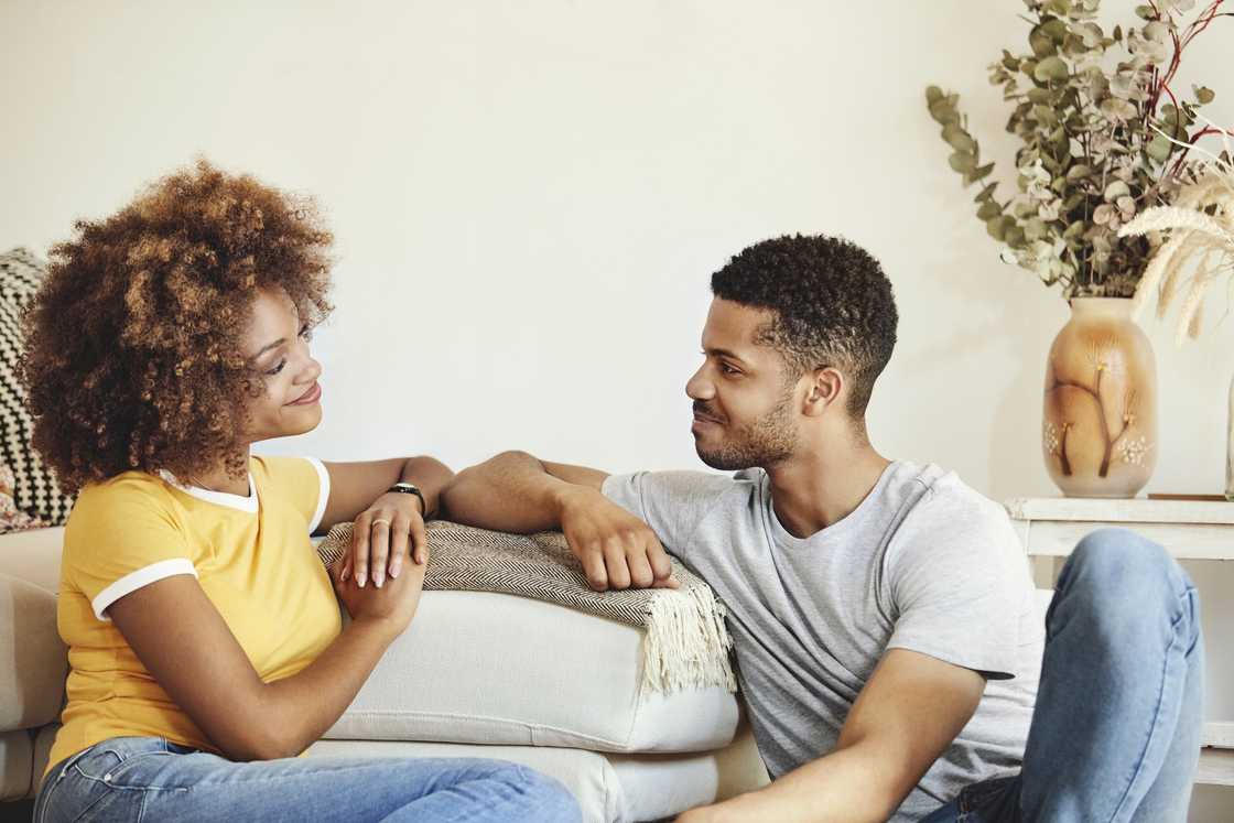 Smiling man and woman looking at each other during a conversation.