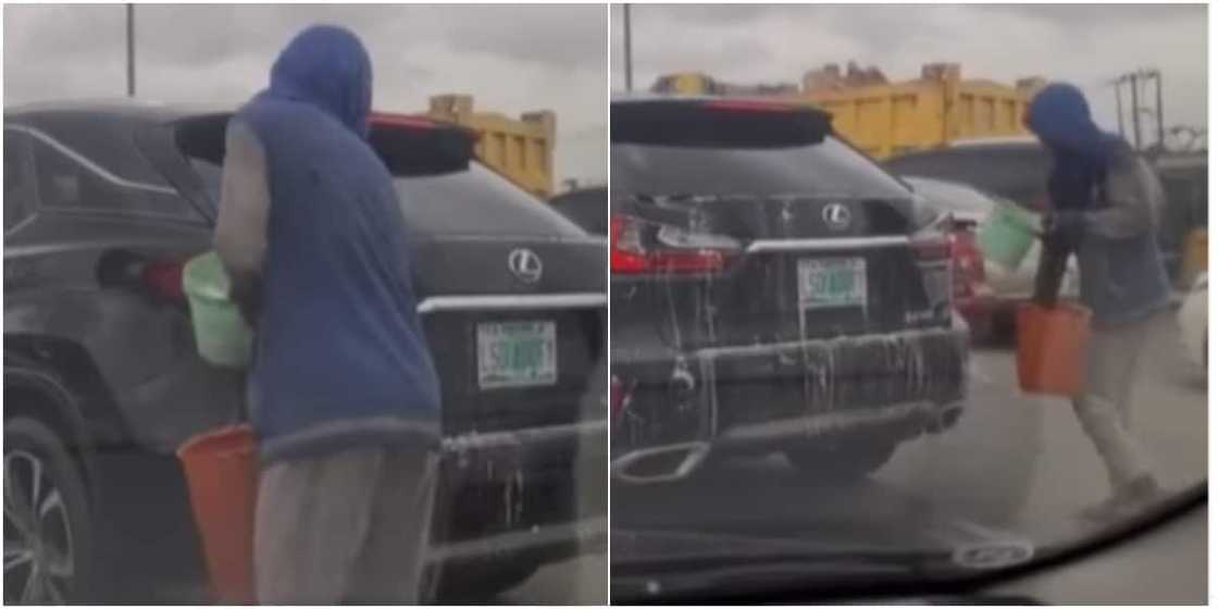 Man washing car in traffic Man washing car in traffic