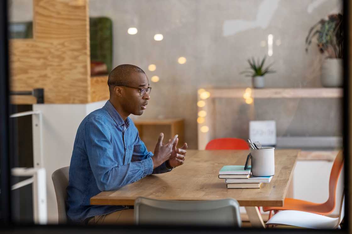 A male entrepreneur talking to a client in office