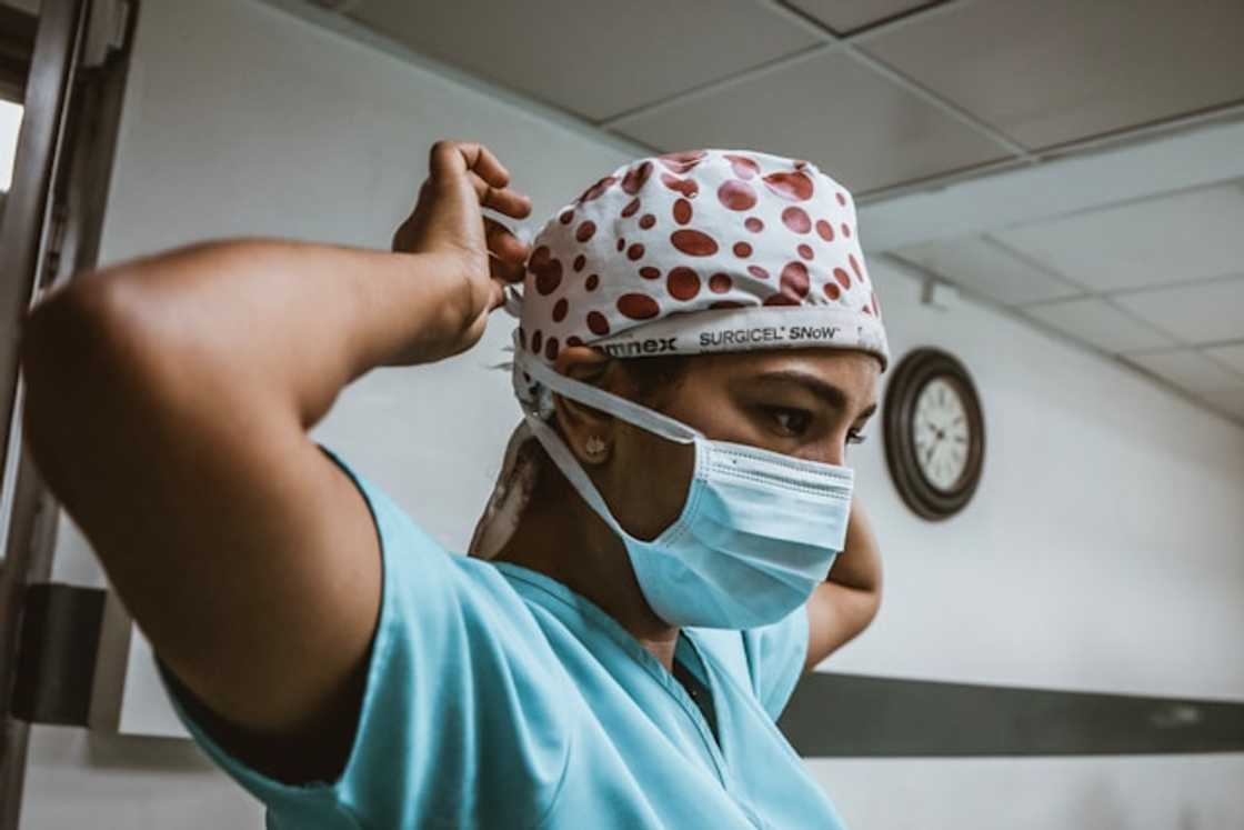 A surgical technician wearing a mask