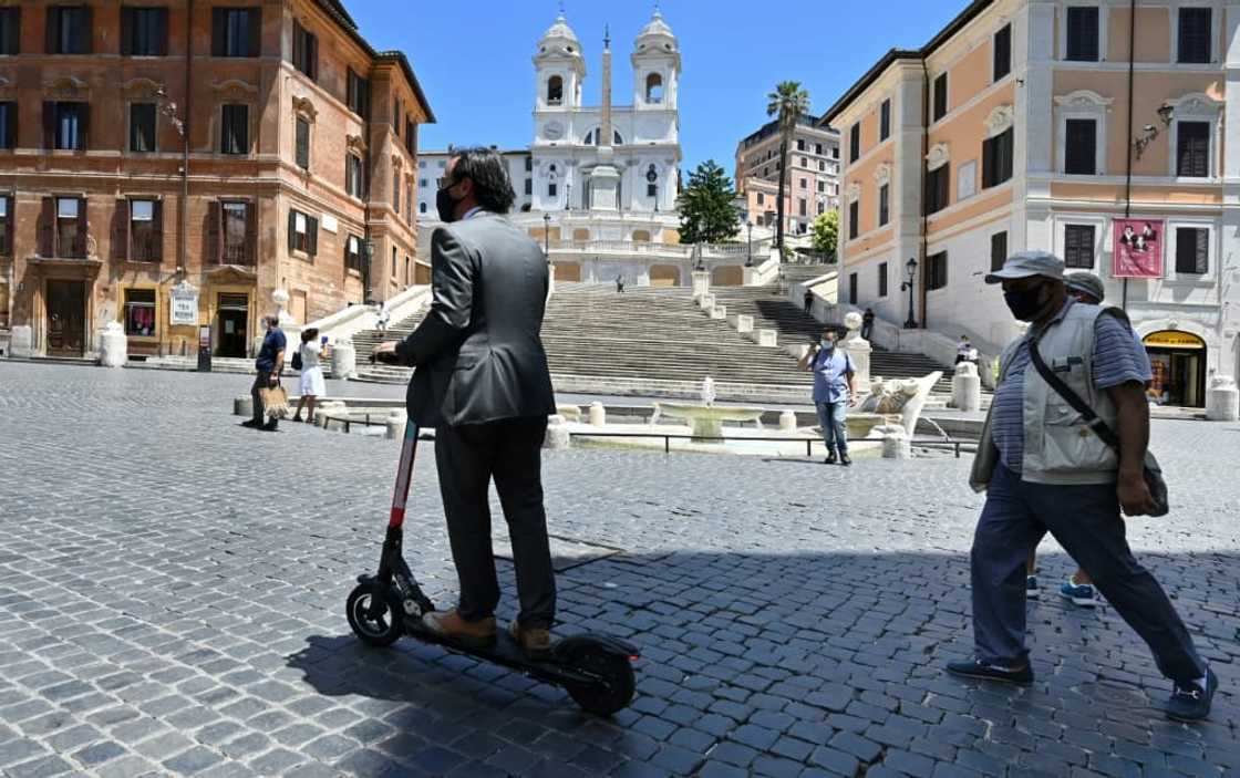 A rider passes the Spanish Steps in Rome, where a project is underway to clamp down on e-scooter use in the city