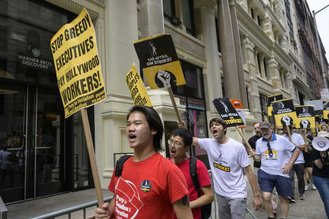 Screen Actors Guild members walk a picket line outside of Warner Bros. Discovery on August 10, 2023, in New York City