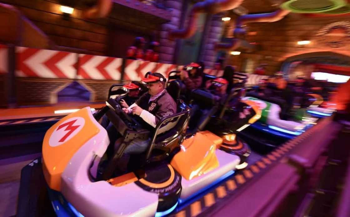 Visitors race along a real-life track surrounded by actual set pieces at the new Super Nintendo World theme park Visitors race along a real-life track surrounded by actual set pieces at the new Super Nintendo World theme park