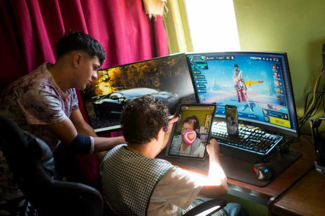Maria Elena Arevalo talks to her TikTok followers, accompanied by her grandson Hector Carrasco Maria Elena Arevalo talks to her TikTok followers, accompanied by her grandson Hector Carrasco