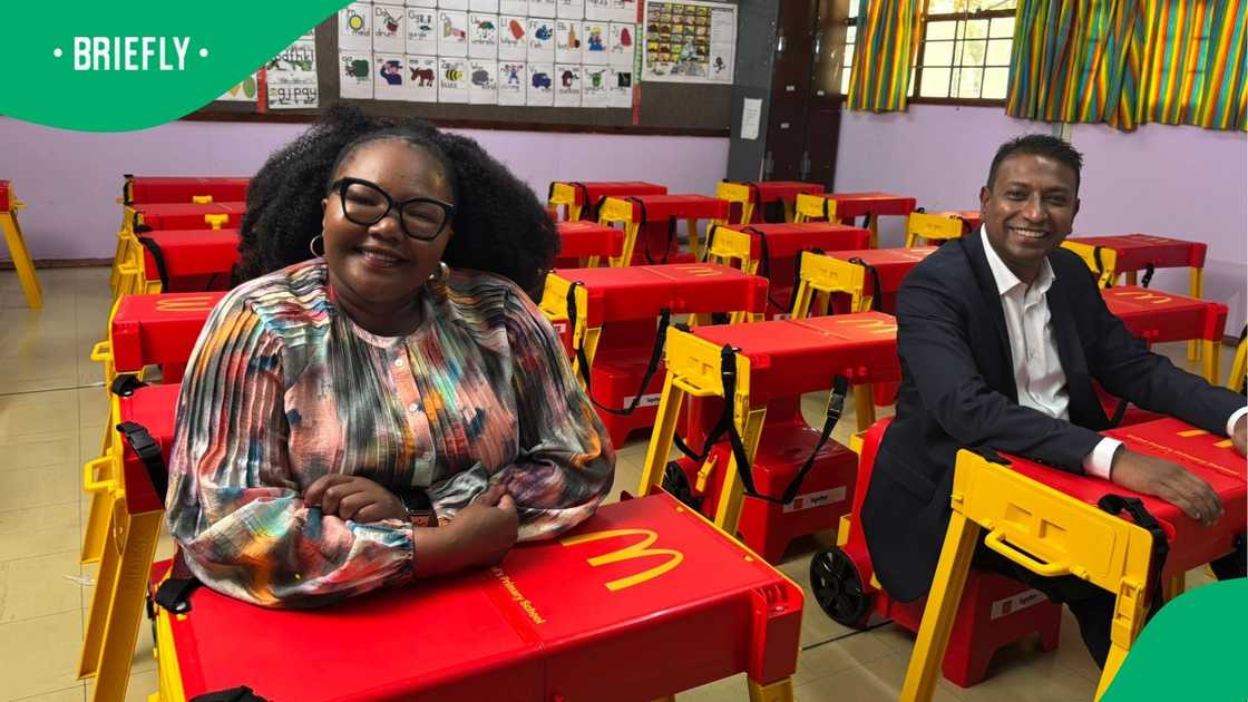 DBE Minister Siviwe Gwarube sitting at a McDonald's-branded desk. DBE Minister Siviwe Gwarube sitting at a McDonald's-branded desk.
