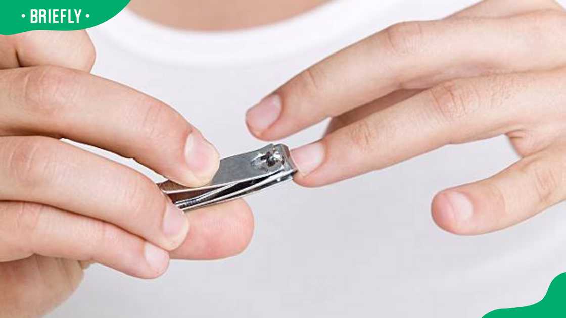 Man clipping his finger nails Man clipping his finger nails