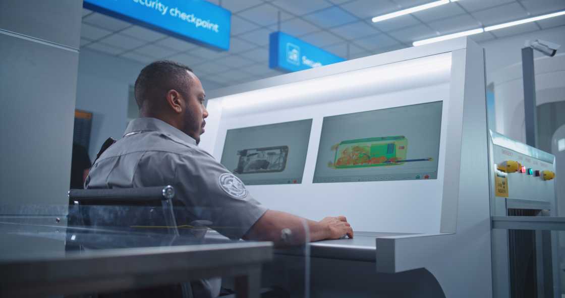 Security officer monitoring luggage in an airport