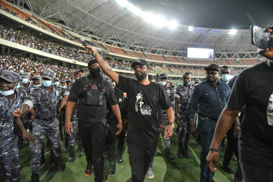 Fally Ipupa has a police escort leaving Abidjan's Olympic stadium in March last year Fally Ipupa has a police escort leaving Abidjan's Olympic stadium in March last year