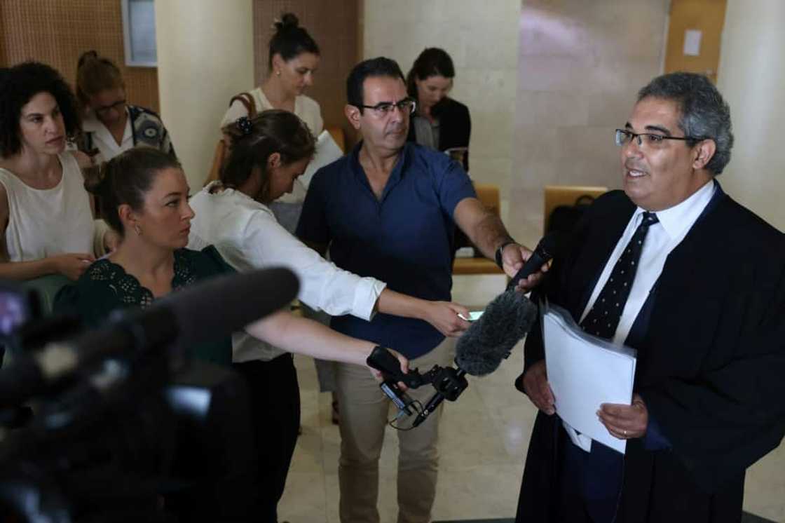 Palestinian lawyer Maher Hanna, the lawyer Mohammed al-Halabi, speaks to reporters after his client was sentenced to 12 years in prison