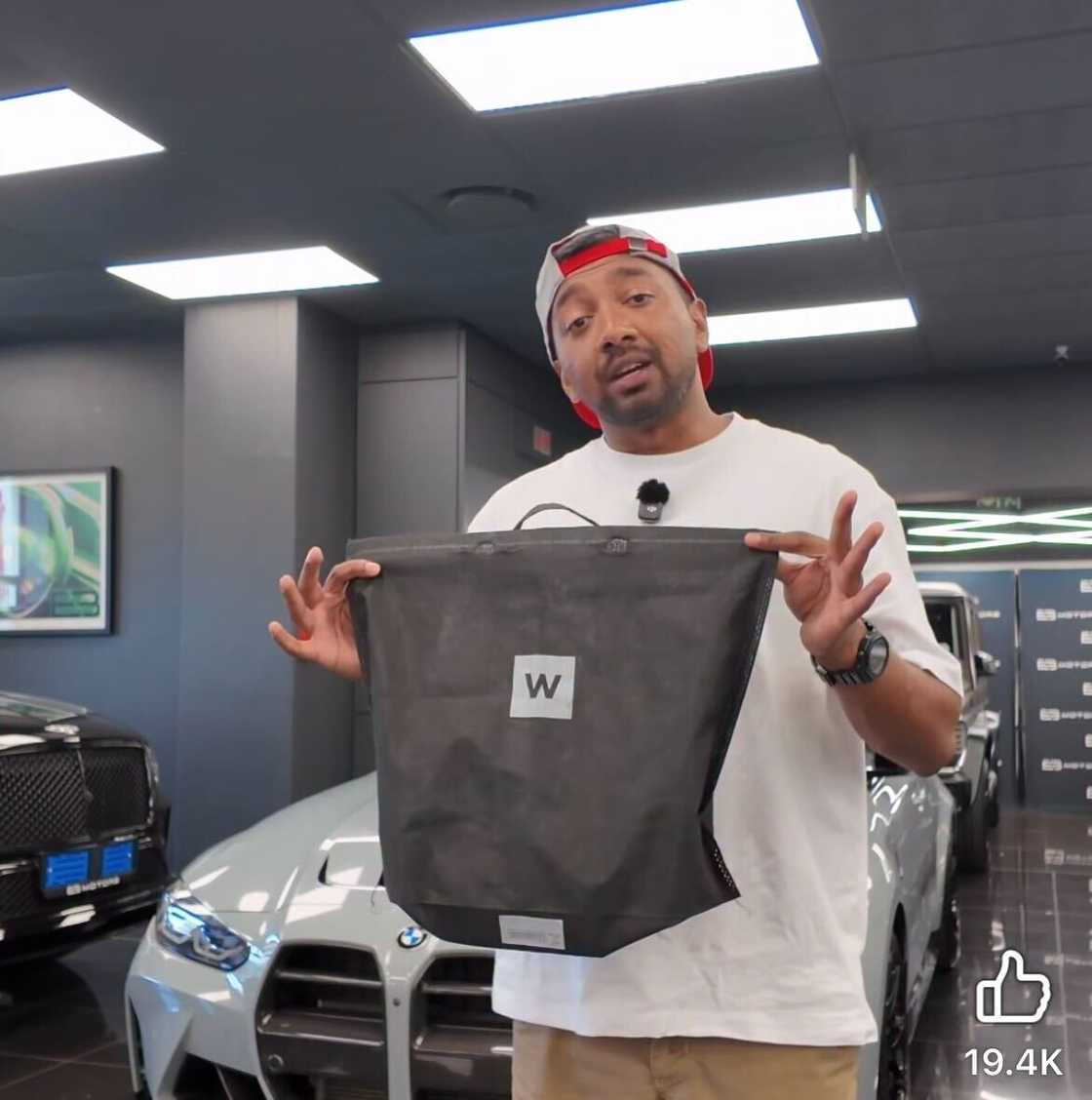A luxury car dealership showcased a Woolworths shopping bag.