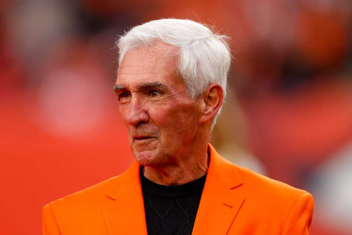 Mike Shanahan stands on the field during halftime against the Washington Football Team