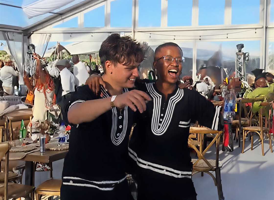 Two men dancing and singing at a wedding in a video that went viral.