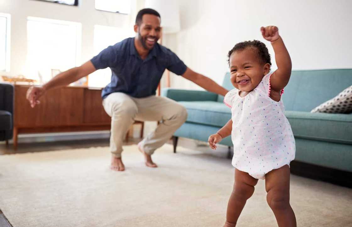 Dad dancing with his baby child.