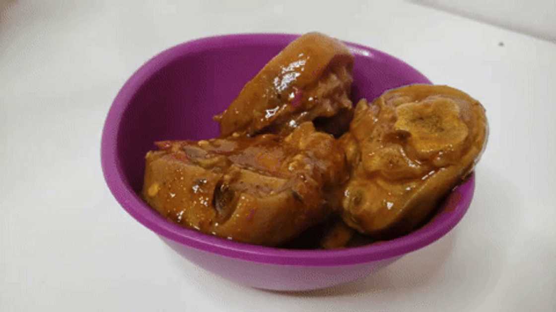 Serving cooked pig's feet in a bowl. Serving cooked pig's feet in a bowl.
