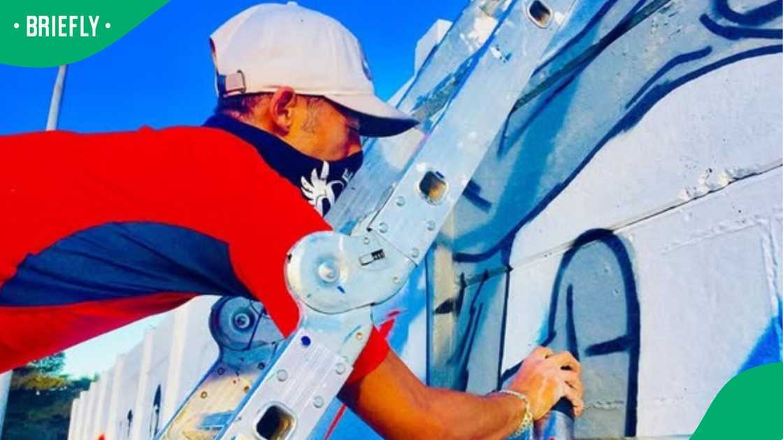 Abdul painting a mural.