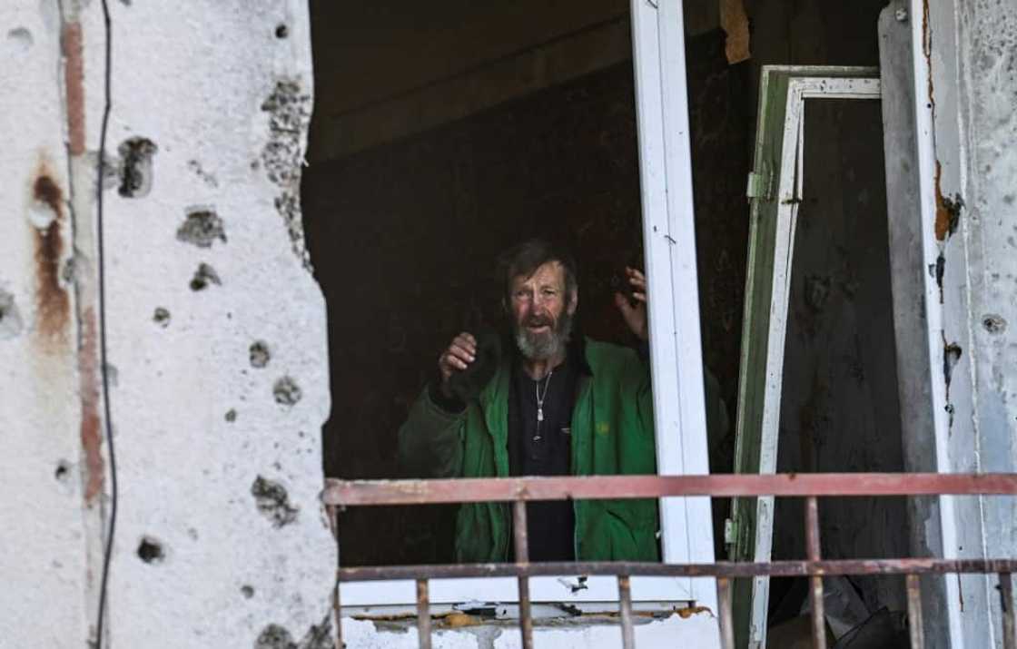 A man gestures inside a damaged building in Hrakove village in September 9, 2022, amid Russian invasion of Ukraine A man gestures inside a damaged building in Hrakove village in September 9, 2022, amid Russian invasion of Ukraine