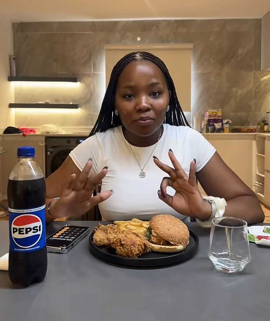 A South African woman trying KFC in Nigeria for the first time.