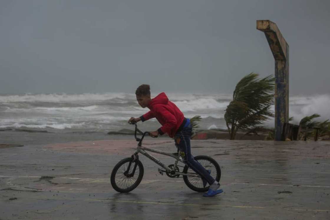 A young person rides his bicycle in Nagua, Dominican Republic A young person rides his bicycle in Nagua, Dominican Republic