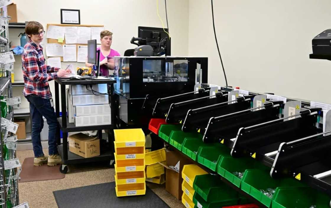 Election workers sort absentee ballots using machines before the U.S. primary in Redding, California