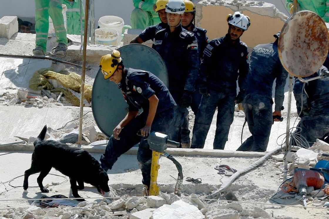 Rescue workers at the disaster site in Jabal al-Weibdeh district, one of Amman's oldest neighbourhoods, known for its vibrant cultural life