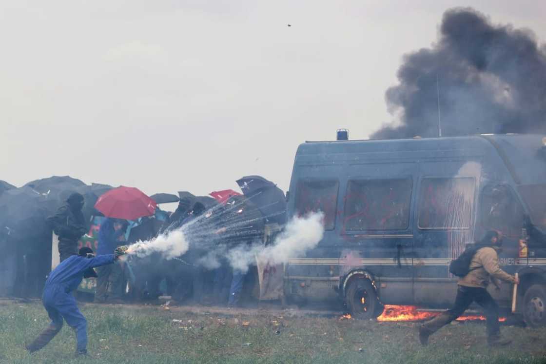 A protester attacks riot police during clashes over irrigation reservoirs in Sainte-Soline, France, on March 25