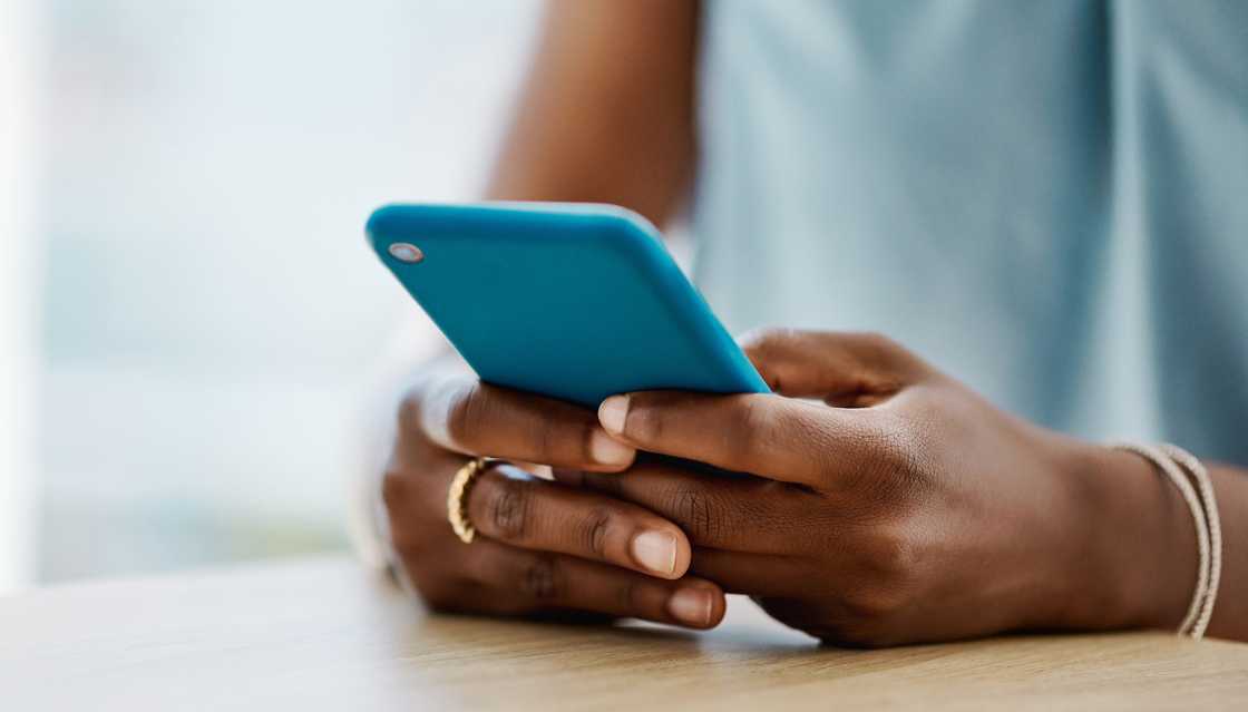 A woman typing on her phone.