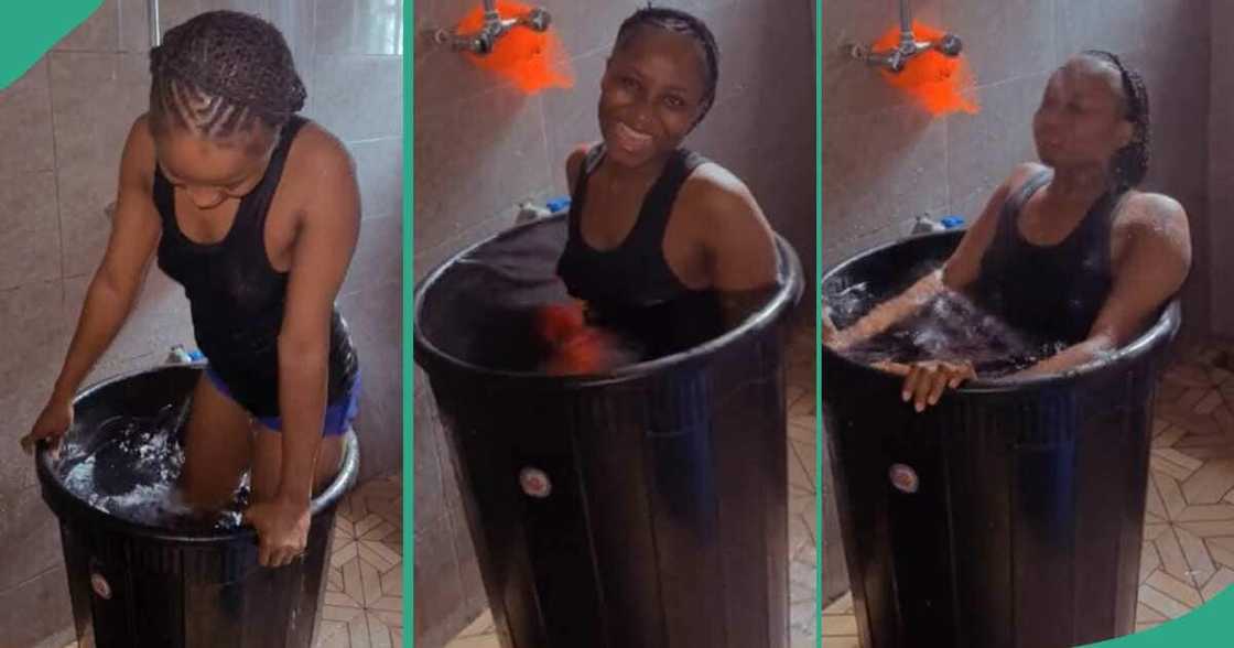 Lady bathing inside a drum of water. Lady bathing inside a drum of water.