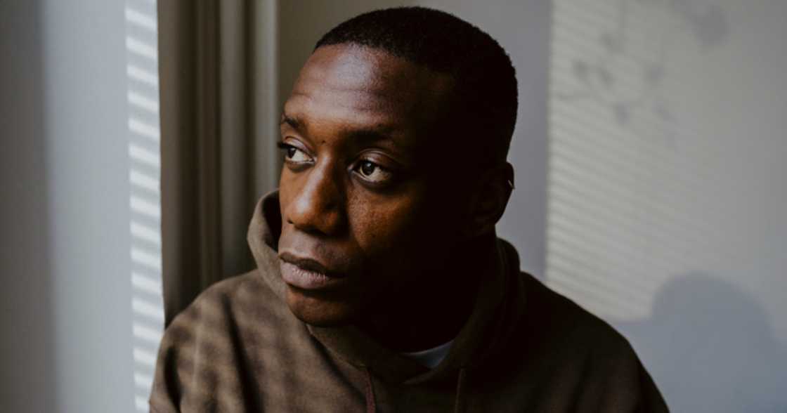 A man reflecting by the window