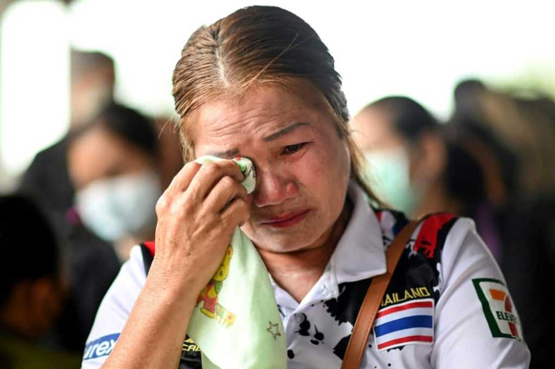 The relative of a victim cries outside the nursery The relative of a victim cries outside the nursery