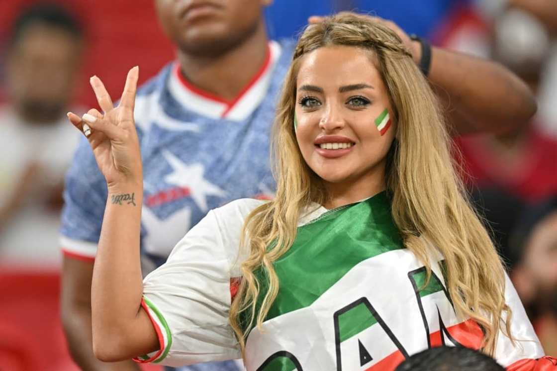 An Iran supporter, draped and painted in the national colours, cheers on her team against the US on Tuesday night An Iran supporter, draped and painted in the national colours, cheers on her team against the US on Tuesday night