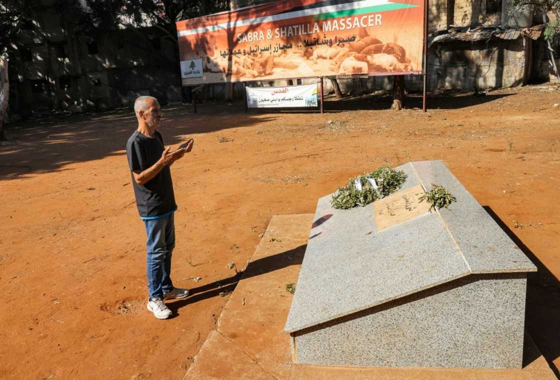 Amer Okkar, a former Palestinian militant, recites a prayer at the mass grave in Sabra