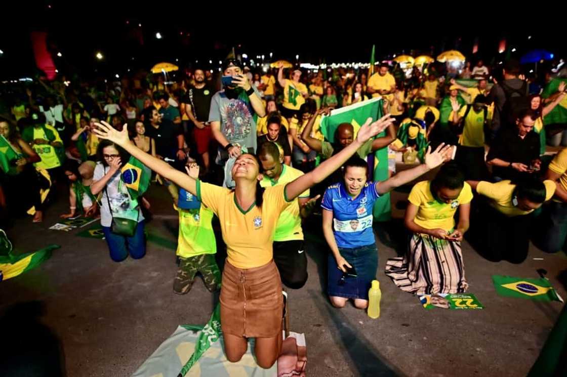 Supporters of Brazilian president and re-election hopeful Jair Bolsonaro prayed -- with no success -- for a political miracle as they watched the vote count in Brasilia Supporters of Brazilian president and re-election hopeful Jair Bolsonaro prayed -- with no success -- for a political miracle as they watched the vote count in Brasilia