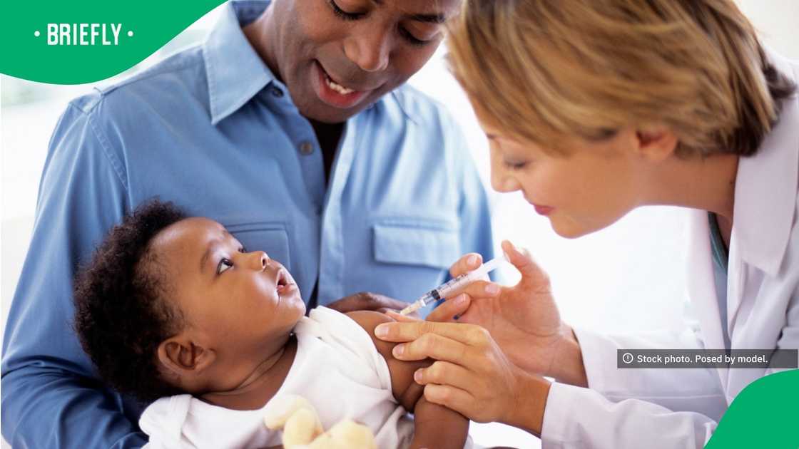 A female paediatrician giving a vaccine to a small baby A female paediatrician giving a vaccine to a small baby