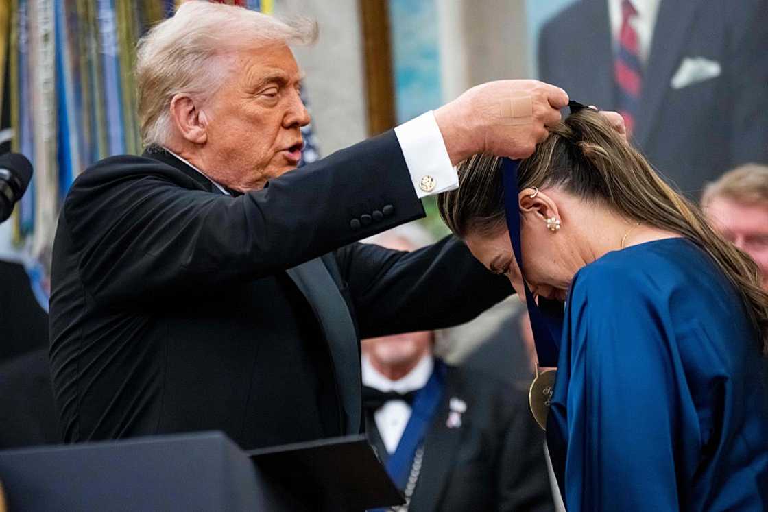 US President Donald Trump presenting a medal to Monique Frehley