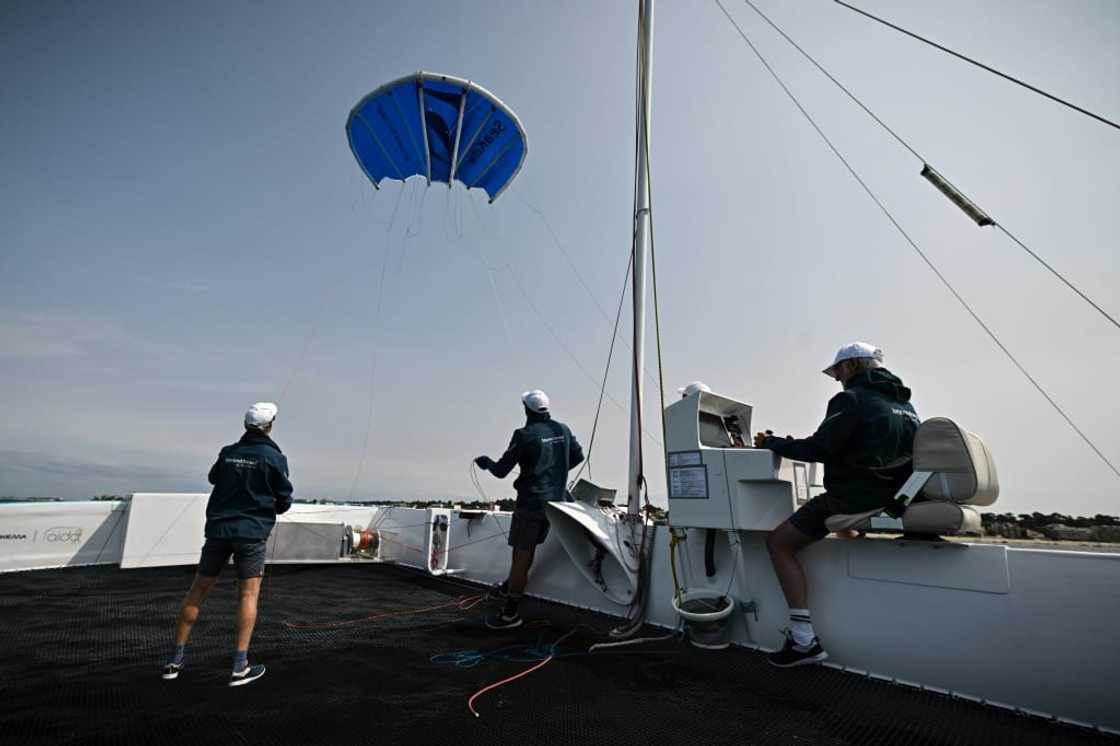 The startup Beyond The Sea tests a blue inflatable kite sail the size of a small studio to pull a specially-designed catamaran across the water The startup Beyond The Sea tests a blue inflatable kite sail the size of a small studio to pull a specially-designed catamaran across the water
