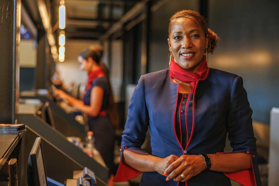 Airport check-in counter with the stewardess smiling. Airport check-in counter with the stewardess smiling.
