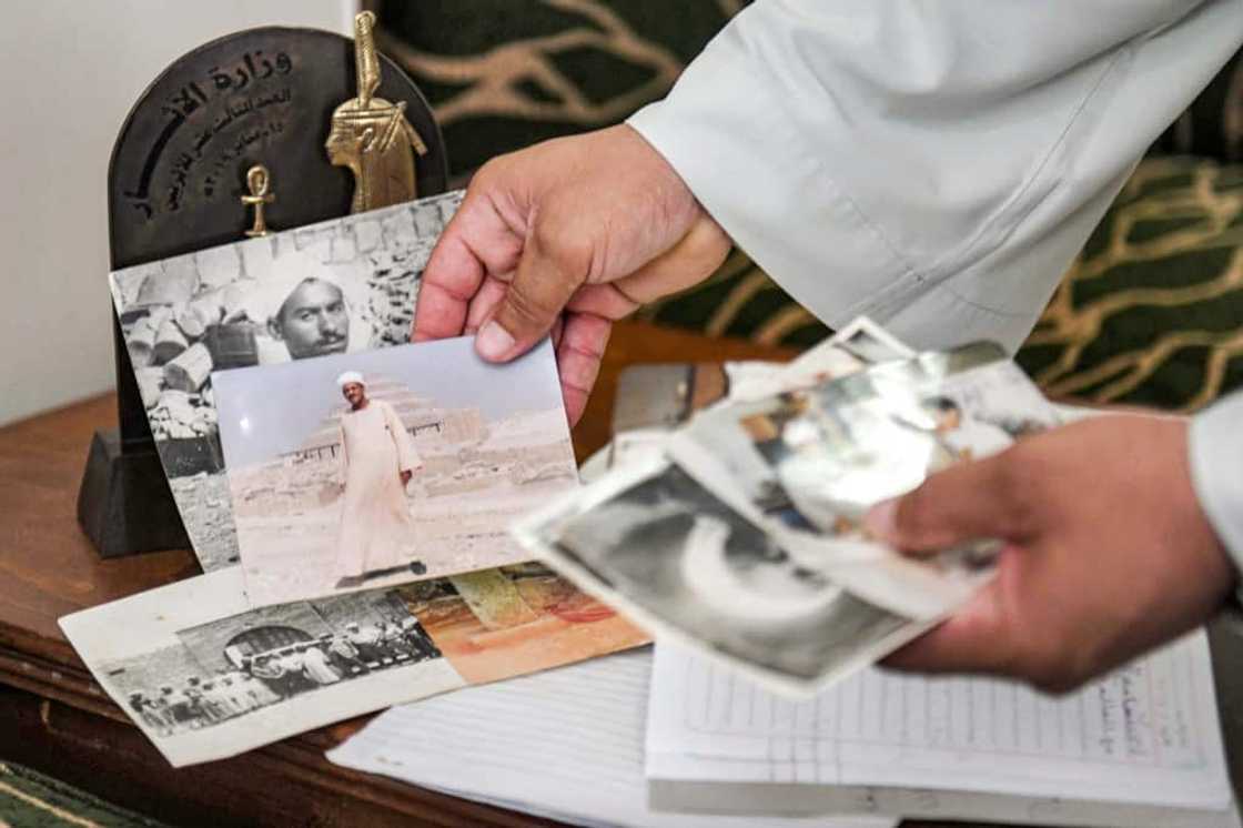 Excavator Mostafa Abdo Sadek shows pictures of family members who helped uncover the treasures of the tombs of Saqqara, southwest of Cairo Excavator Mostafa Abdo Sadek shows pictures of family members who helped uncover the treasures of the tombs of Saqqara, southwest of Cairo