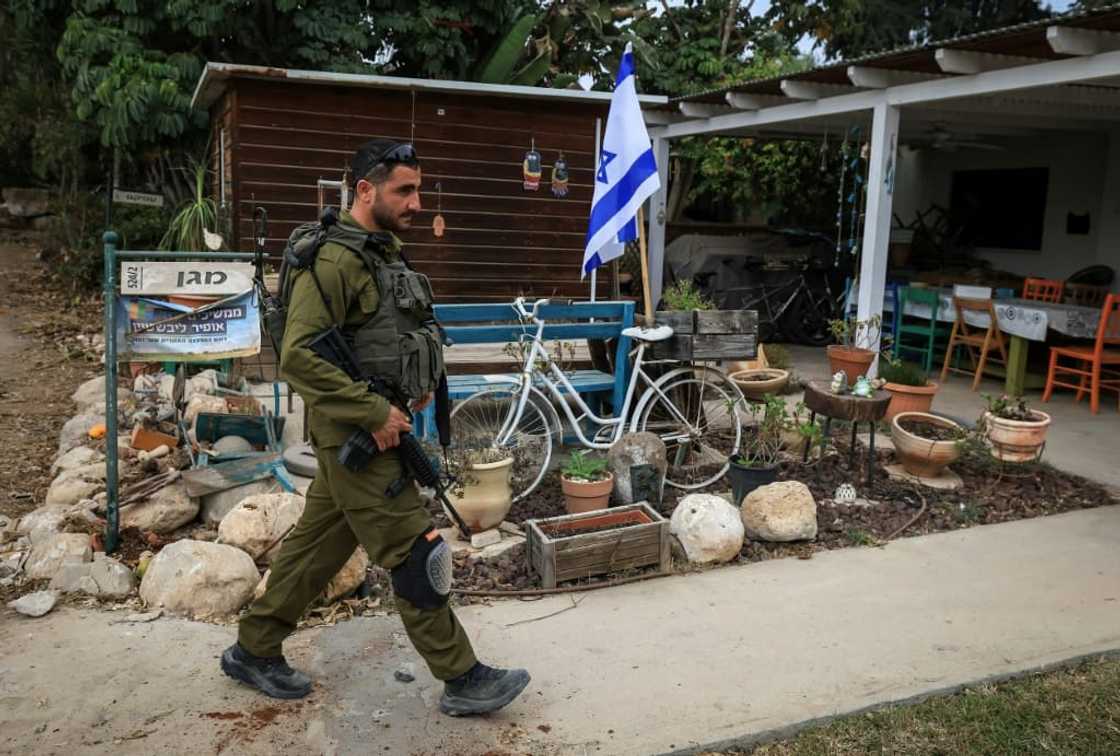 An Israeli soldier in Kibbutz Kfar Aza, which was attacked by Hamas militants, close to the southern Israeli border with the Gaza Strip on October 27, 2023