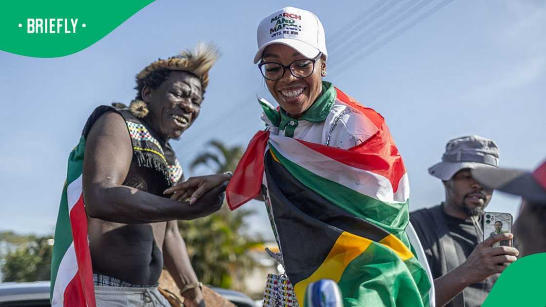 March and March Movement leader Jacinta Ngobese-Zuma is assisted by a supporter to address hundreds of protestors during a protest demonstration in Pinetown, south of Durban on July 16, 2026