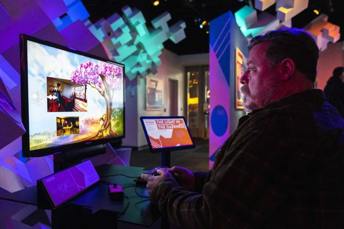 Gamer Stefan Montgomery plays 'The Light in the Darkness' at the Museum of Pop Culture in Seattle -- the game is available for play on computers, with console versions to follow soon Gamer Stefan Montgomery plays 'The Light in the Darkness' at the Museum of Pop Culture in Seattle -- the game is available for play on computers, with console versions to follow soon