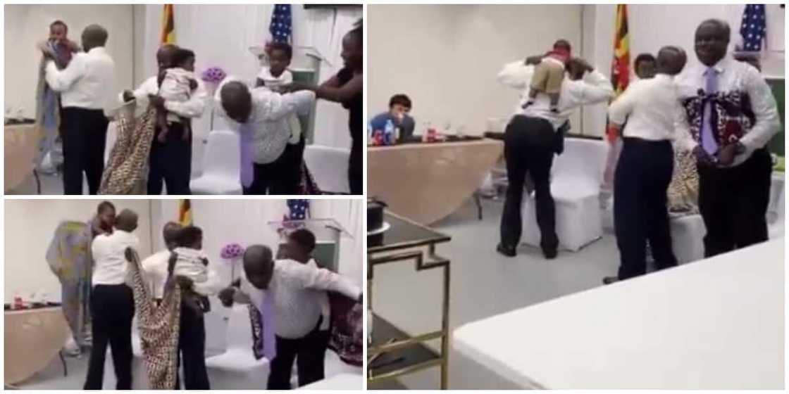 Fathers on corporate wear attempt to carry babies on their backs with wrappers in adorable video Fathers on corporate wear attempt to carry babies on their backs with wrappers in adorable video
