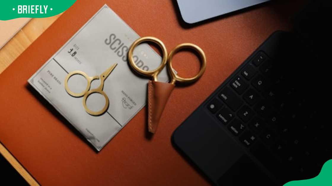 A pair of gold scissors on a table A pair of gold scissors on a table