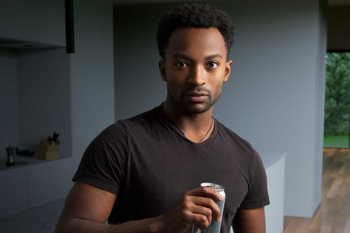 A man is holding a can A man is holding a can