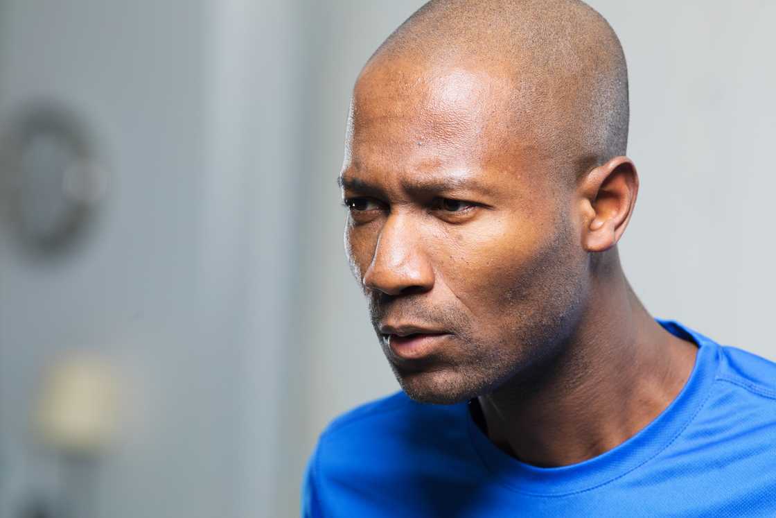 A middle-aged man looking forward with a frown. A middle-aged man looking forward with a frown.