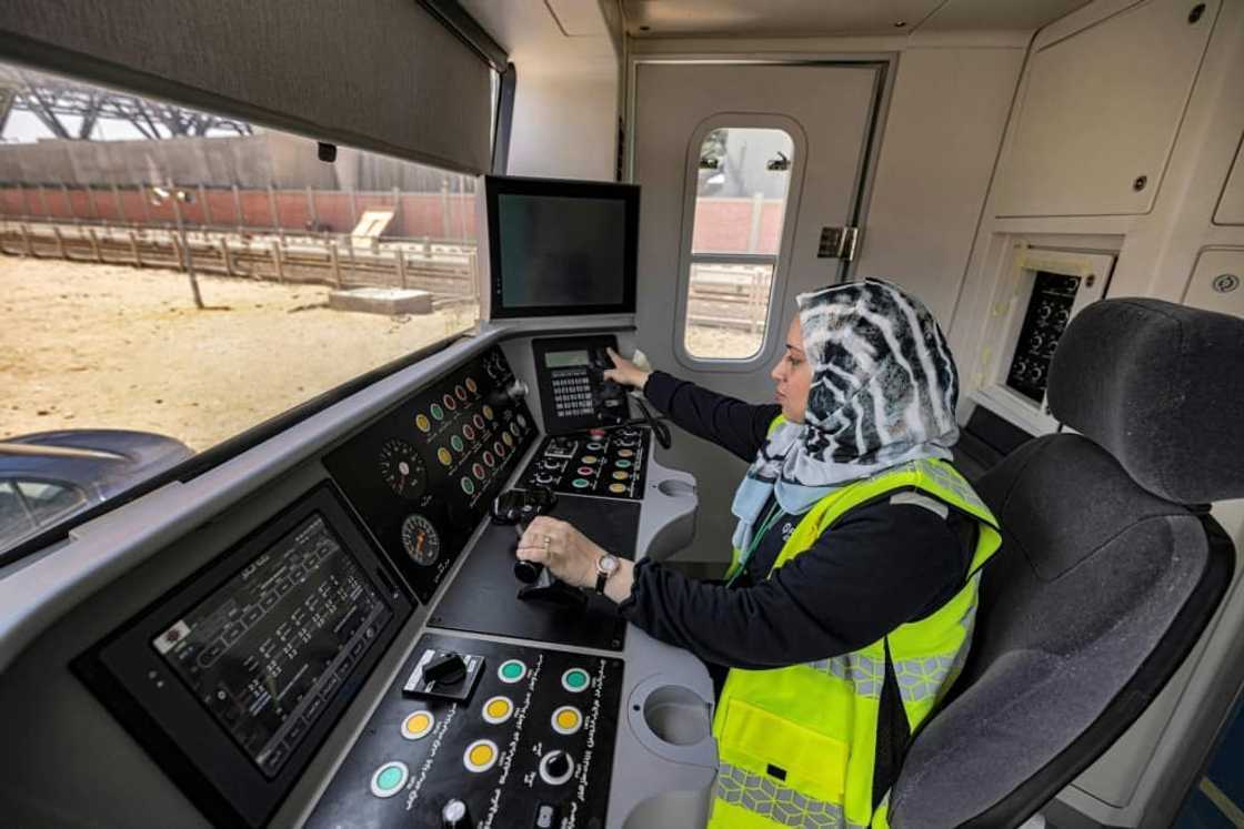 Hind Omar, shown in a full-size train simulator, is one of the first two women hired to take the controls of trains on Cairo's metro