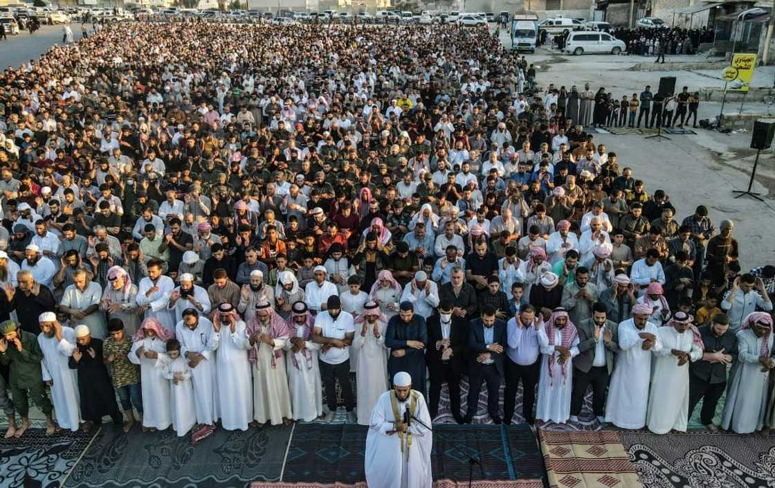 Muslims gather to perform the morning prayer in Bab al-Hawa near the border with Turkey on the Eid al-Adha holiday on July 9