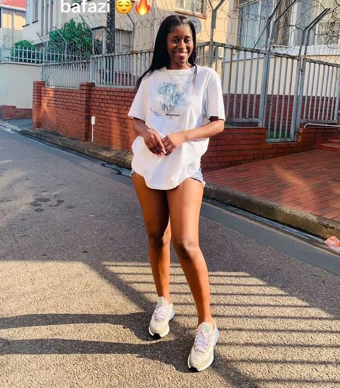 A woman in South Africa posed in a TikTok video while dressed in a short white top. A woman in South Africa posed in a TikTok video while dressed in a short white top.