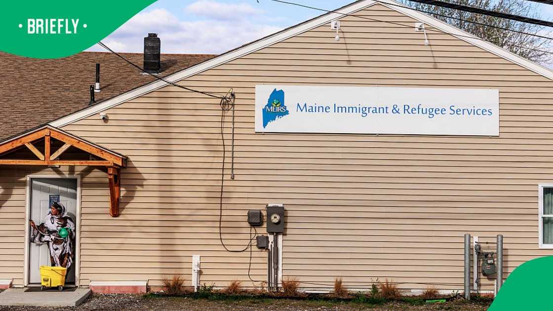 A woman carries a mop bucket into the Maine Immigrant and Refugee Services building in Lewiston, Maine, Sunday, May 3, 2026